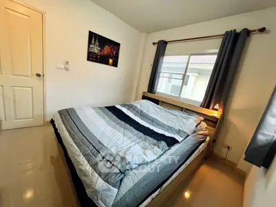 Cozy bedroom with large window and modern decor