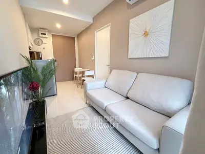 Modern living room with stylish decor and comfortable seating in a cozy apartment.