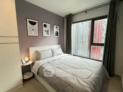Modern bedroom with stylish decor and large window in urban apartment