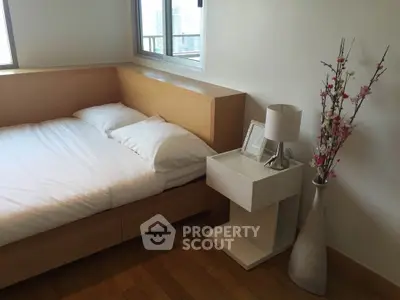 Modern minimalist bedroom with wooden flooring and stylish decor