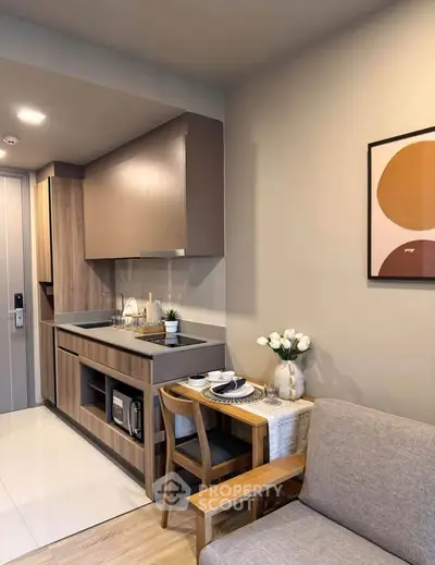 Modern compact kitchen with dining area in stylish apartment