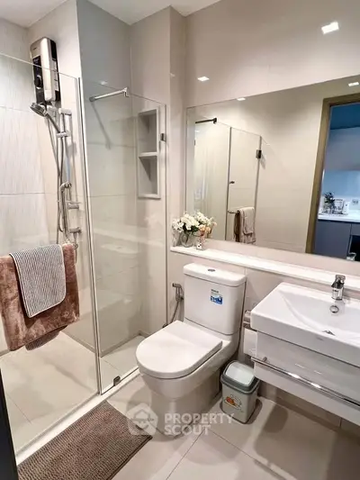 Modern bathroom with glass shower, sleek fixtures, and elegant decor