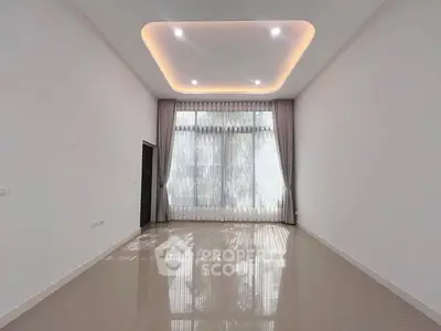 Spacious modern living room with high ceiling and elegant lighting