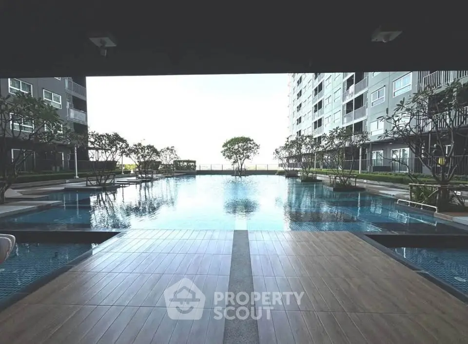 Luxurious condominium pool area with modern design and serene ambiance.