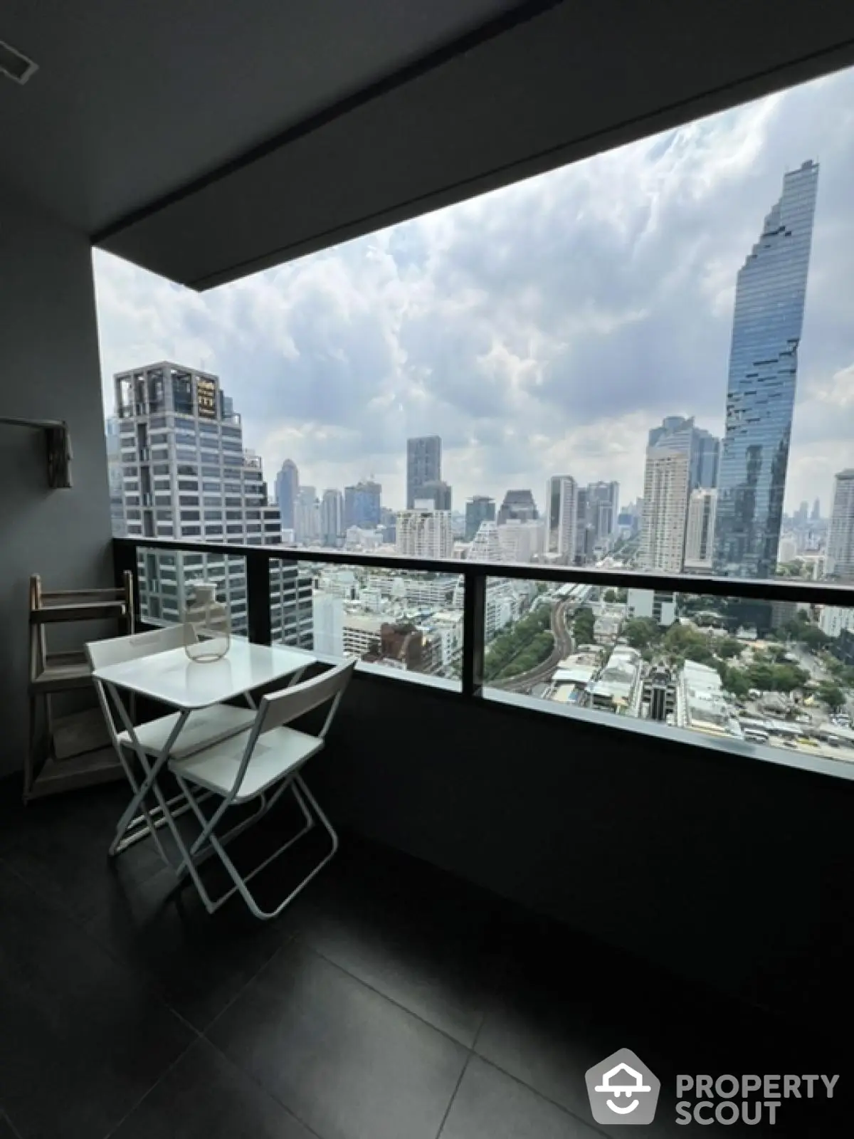 Stunning cityscape view from modern balcony with sleek furniture