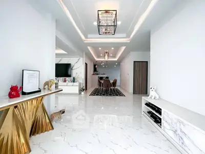 Luxurious open-plan living room with elegant decor and marble flooring