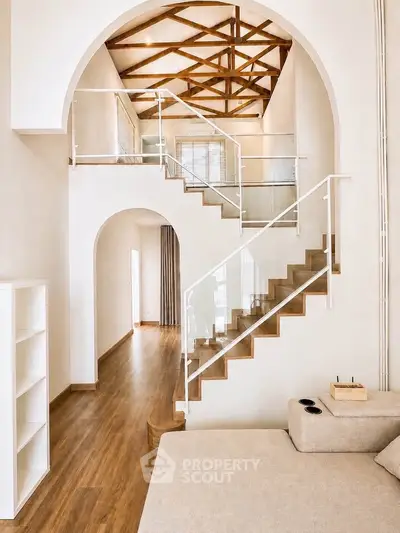 Stunning modern living room with high ceilings and elegant staircase