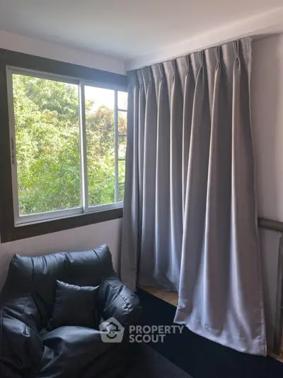 Cozy corner with armchair and window view in modern home interior