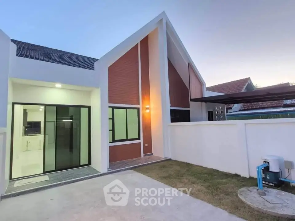 Modern single-story house with unique roof design and spacious outdoor area, perfect for family living.