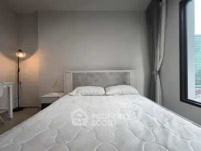 Modern bedroom with large window and stylish decor