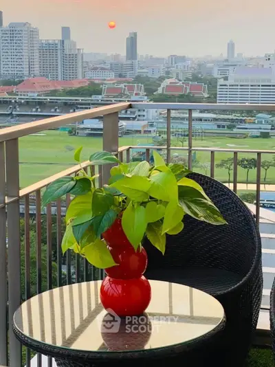 Stunning balcony view with lush greenery and cityscape, perfect for relaxation and enjoying sunsets.