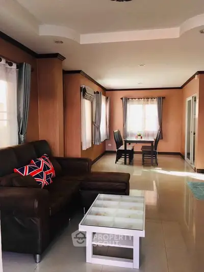 Spacious living room with elegant dining area and natural light, perfect for modern living.