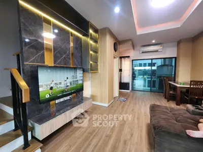 Modern living room with stylish decor, wooden flooring, and a cozy seating area, perfect for relaxation.