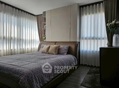Luxurious bedroom with elegant decor and large windows for natural light