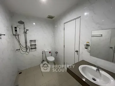 Modern bathroom with sleek fixtures and marble walls