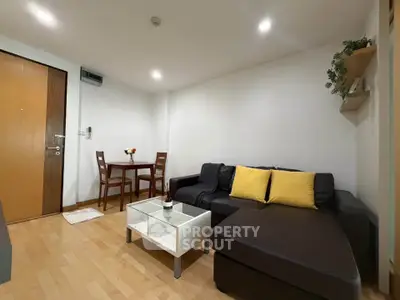 Cozy living room with modern furniture and wooden flooring in a stylish apartment.