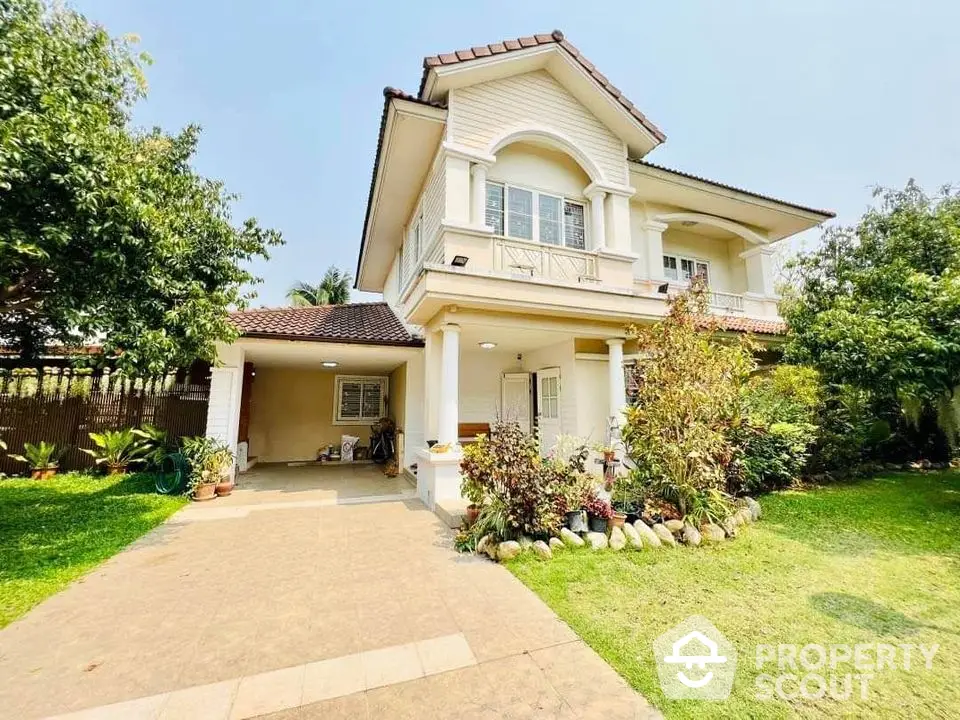 Charming two-story house with lush garden and spacious driveway in a serene neighborhood.