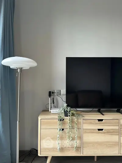 Modern living room with sleek TV stand and stylish floor lamp