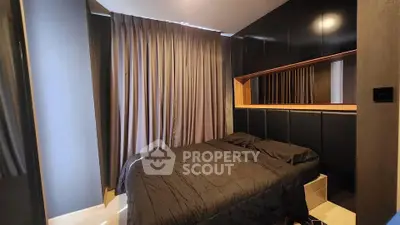 Modern bedroom with sleek black decor and cozy ambiance