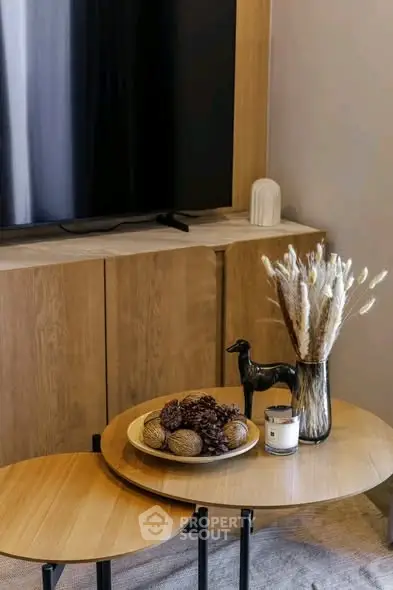 Stylish living room with modern decor and wooden furniture, perfect for cozy gatherings.