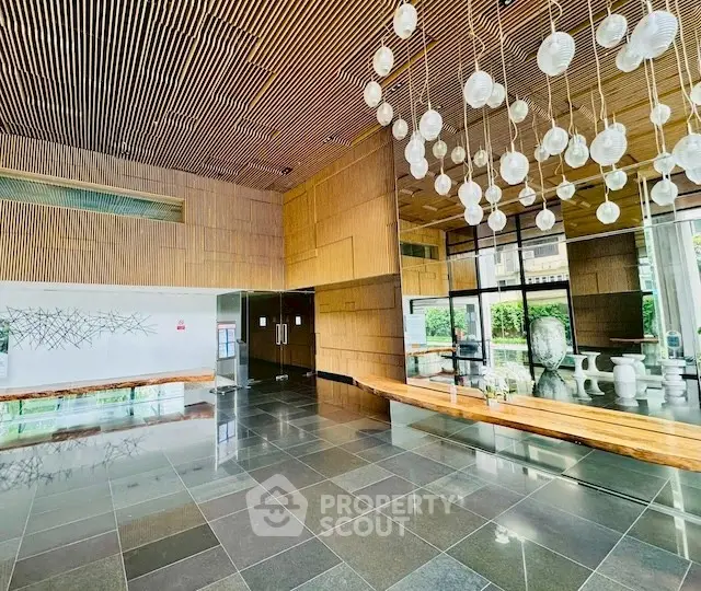 Luxurious modern building entrance with elegant lighting and sleek design.