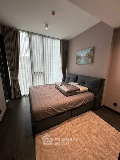 Modern bedroom with large windows and stylish decor