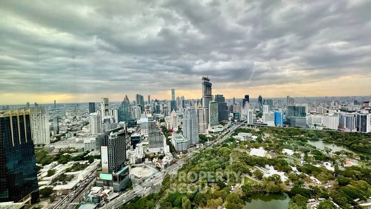 Stunning cityscape view from a high-rise building showcasing urban skyline and lush green park.
