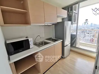Modern kitchen with city view, featuring sleek cabinetry, stainless steel appliances, and a balcony.