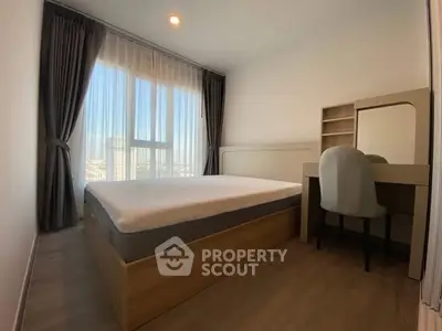 Modern bedroom with large window and stylish furniture in a high-rise apartment.