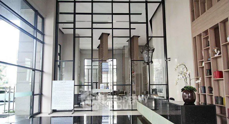 Luxurious modern building entrance with high ceilings and elegant decor