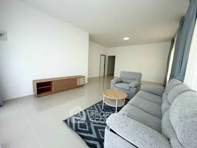 Spacious modern living room with sleek furniture and natural light