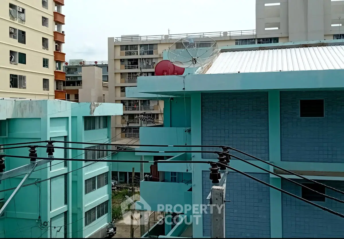 Urban residential buildings with satellite dish and vibrant blue facade