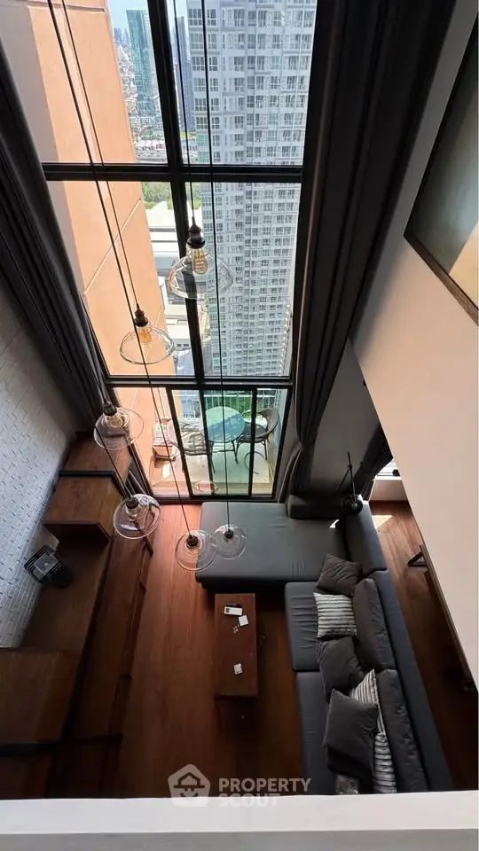 Stunning high-rise living room with floor-to-ceiling windows and breathtaking city view.