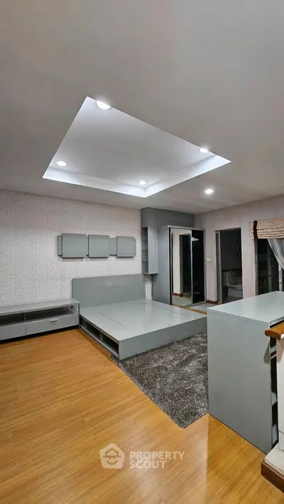 Modern living room with recessed lighting and sleek furniture design