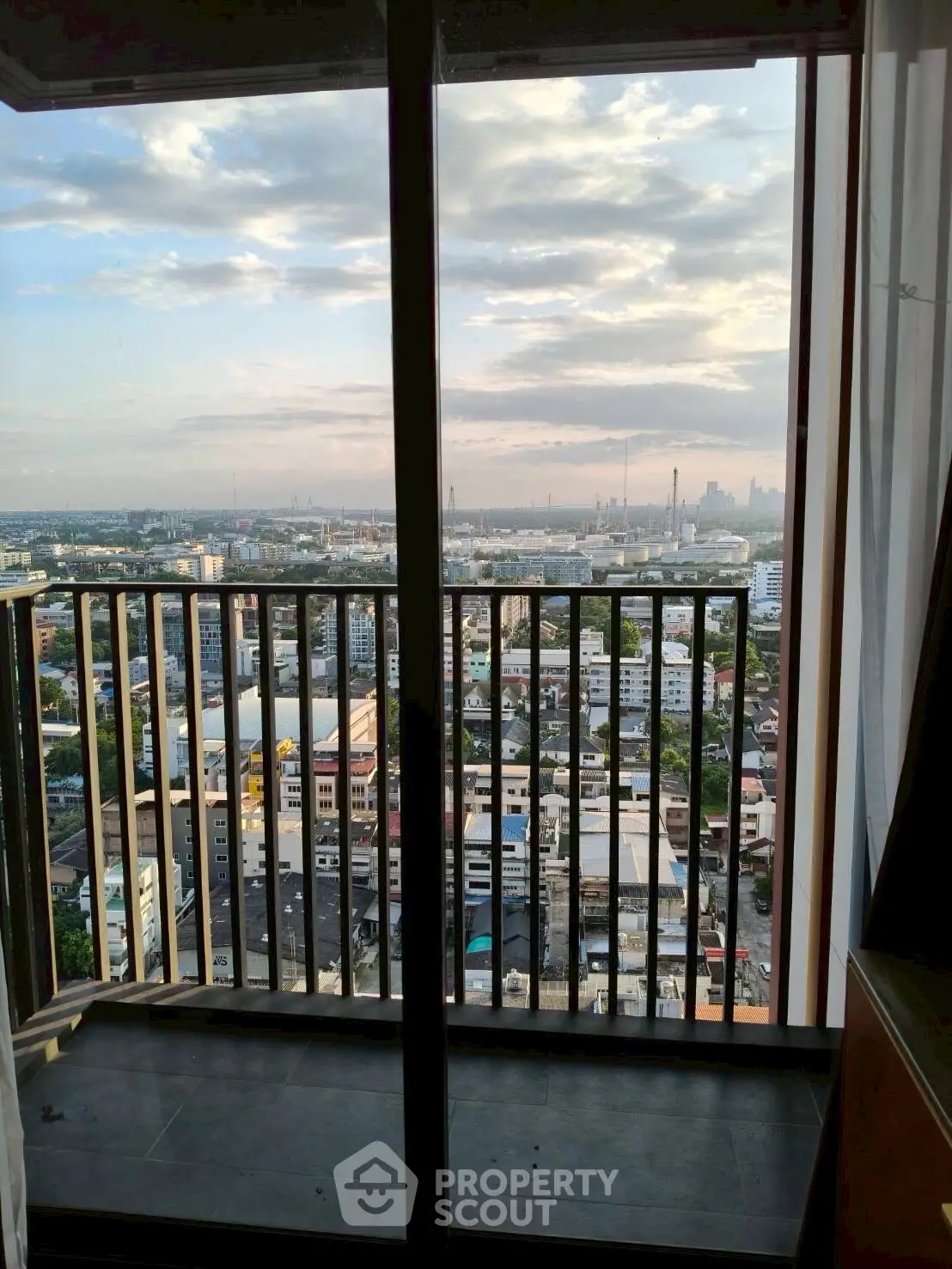 Stunning cityscape view from a high-rise balcony, perfect for urban living.
