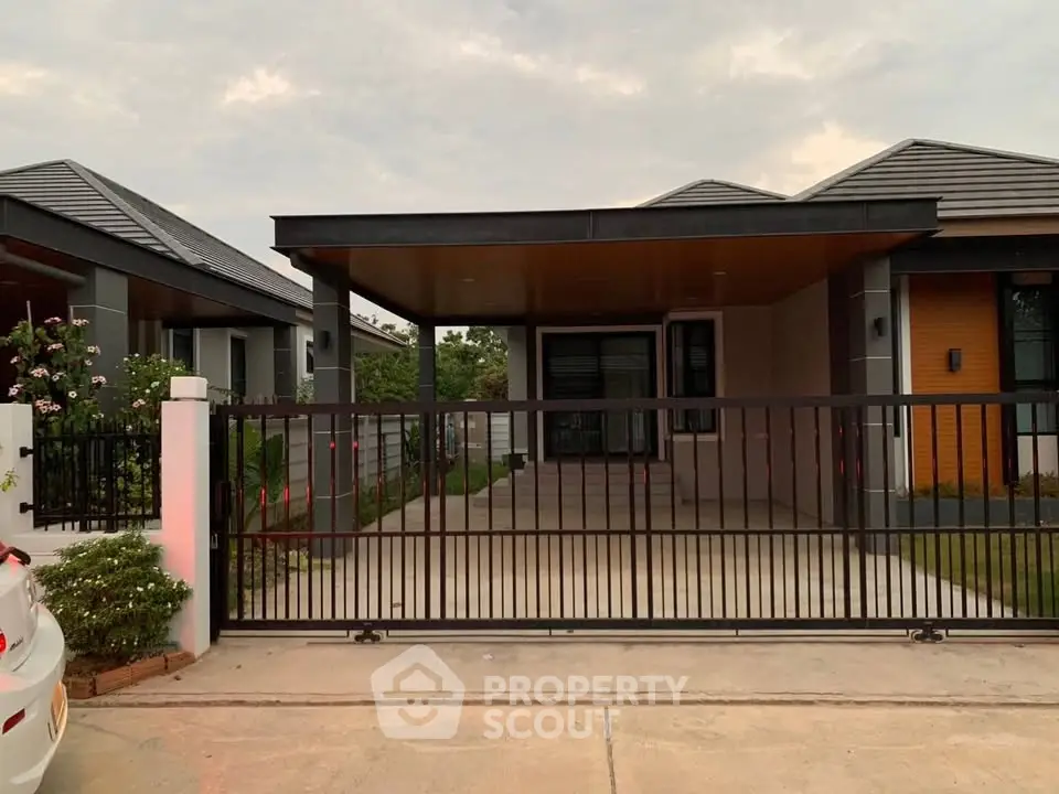 Modern single-story house with sleek design and spacious driveway in a serene neighborhood.