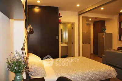Modern studio apartment with cozy bedroom and open layout kitchen, ideal for urban living.