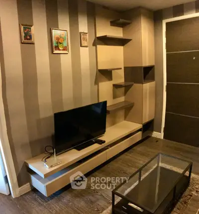Modern living room with stylish TV unit and wall shelves, perfect for contemporary living.