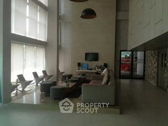 Spacious modern living room with high ceilings and stylish furniture in a luxury apartment.