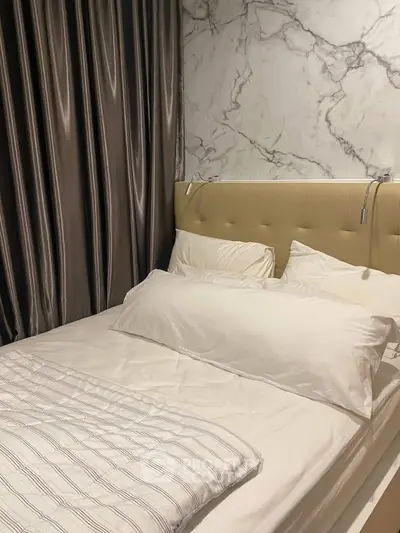 Luxurious bedroom with marble accent wall and elegant curtains