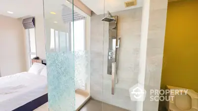 Modern bathroom with glass shower and adjacent bedroom in luxury apartment