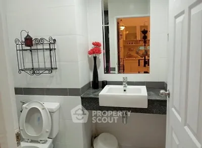 Modern bathroom with sleek sink and decorative elements in a stylish apartment.