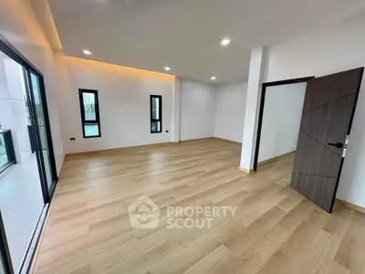 Spacious modern living room with wooden flooring and large windows