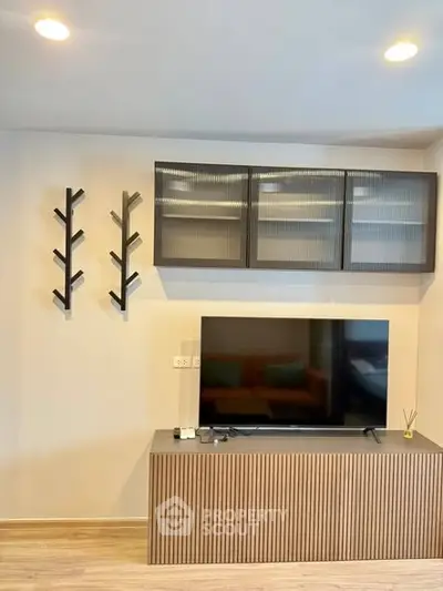 Modern living room with sleek TV stand and stylish wall-mounted shelves