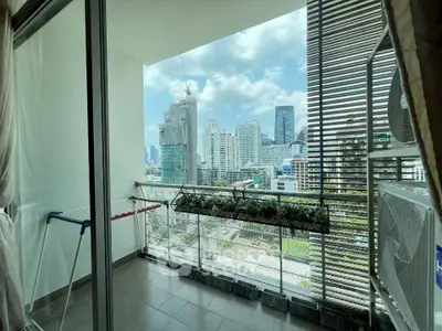 Modern apartment balcony with stunning city skyline view, perfect for urban living.
