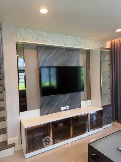 Modern living room with sleek TV unit and elegant decor, perfect for stylish urban living.