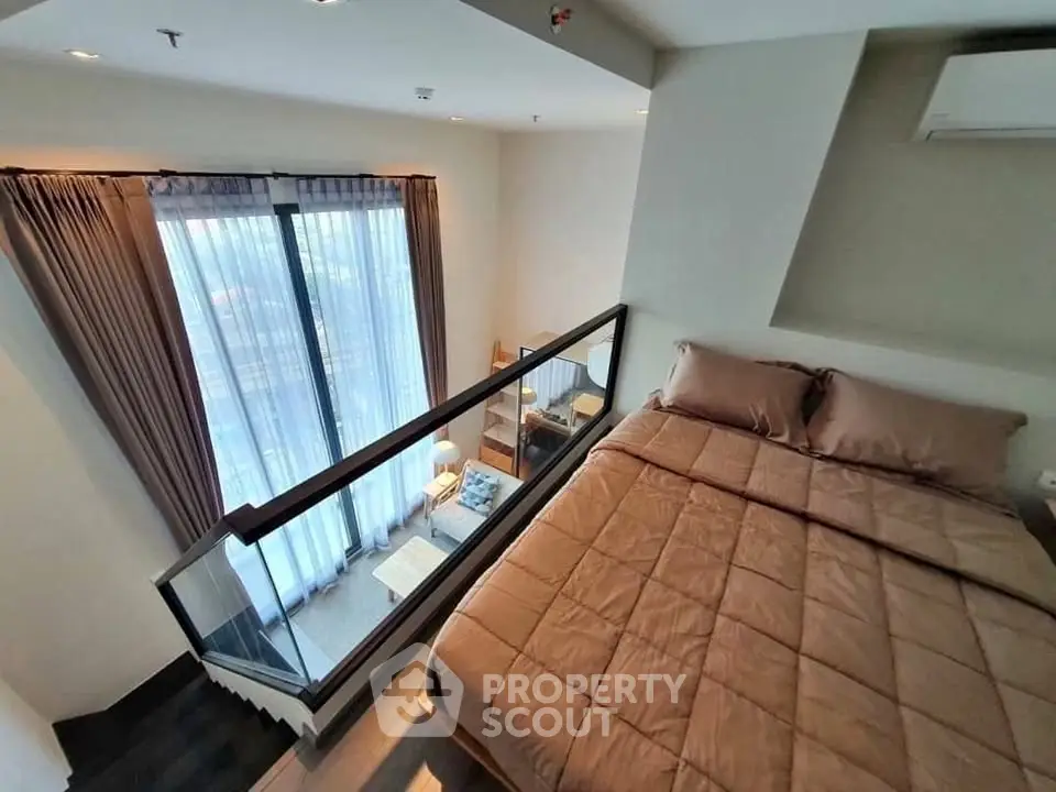 Modern loft bedroom with large windows and cozy decor