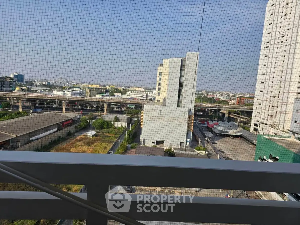 Urban balcony view with cityscape and distant buildings