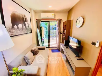 Cozy living room with modern decor, featuring a large elephant artwork and sliding glass doors to a balcony.