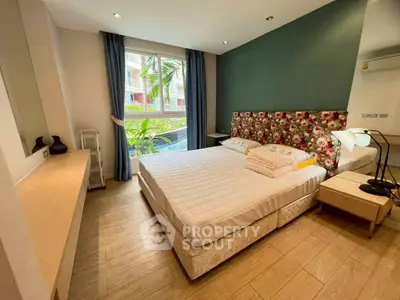Cozy bedroom with floral headboard and large window view